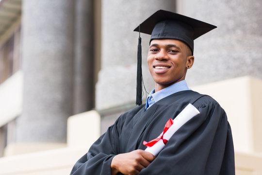 african american male graduate standing outside college