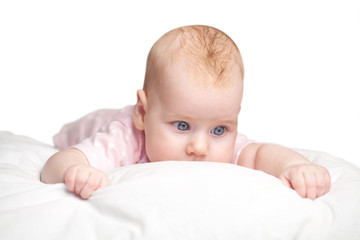 little girl lies on a pillow