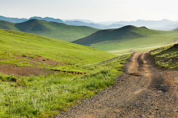 Winding dirt road through Central Mongolian steppe