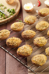 Baked eggs, stuffed with ham and parsley