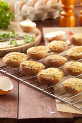 Baked eggs, stuffed with ham and parsley