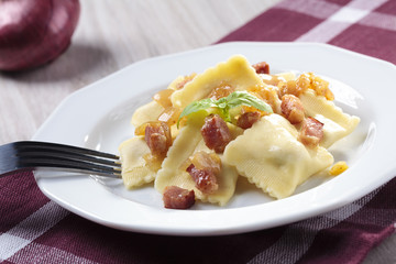 Portion of ravioli with onion and bacon