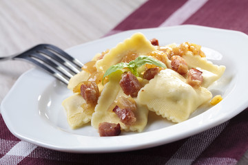 Portion of ravioli with onion and bacon