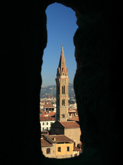 Badia Fiorentina  church seen through old stone window