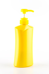 Fototapeta na wymiar Yellow bottle pump isolated on white background