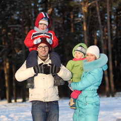 young family walks winter