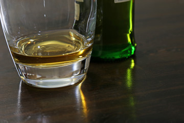 A small amount of scotch whisky sitting on a table..
