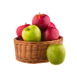 Red and green apples in a wooden basket on white background.