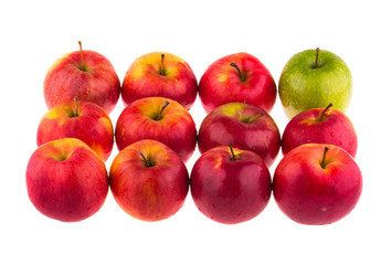 Green apple among red apples on white background.