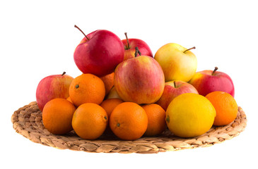Fresh apples, tangerines and lemons on a straw mat.