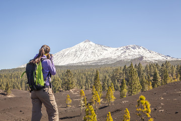 Woman nature Photographer taking pictures outdoors during hiking