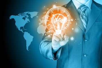 Business man touching light of idea