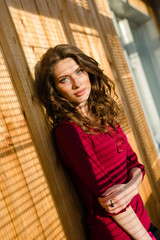 beautiful blue eyes girl with shadow from window blinds