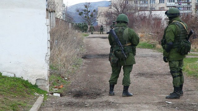 Russian soldiers guarding a naval base in Perevalne, Ukraine