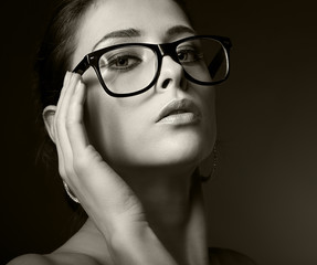 Fototapeta premium Sexy woman in glasses looking hot. Black and white portrait