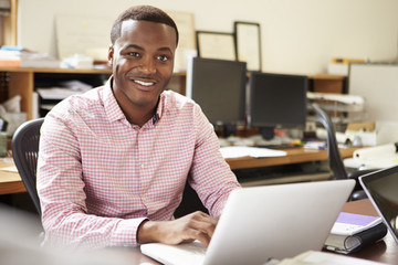 Male Architect Working At Desk On Laptop