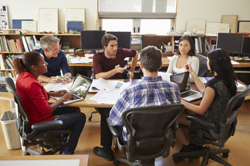 Group Of Architects Meeting Around Desk