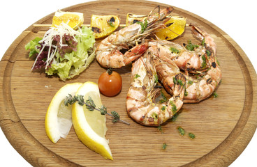 grilled shrimp with lemon on wooden platter