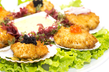 fried scallops decorated with caviar and greens