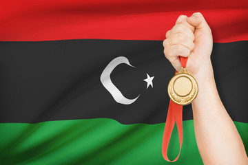 Fototapeta na wymiar Medal w parze z flagą w tle - stan Libii