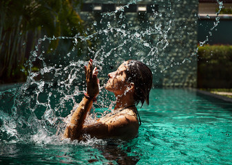 beautiful female model posing by the pool, outdoor portrait