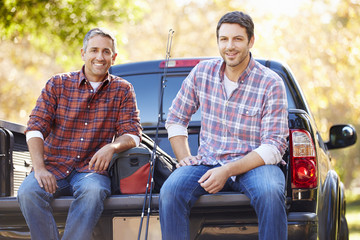 Portrait Of Two Men In Pick Up Truck On Camping Holiday - obrazy, fototapety, plakaty