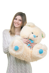 Young girl holding big teddy bear