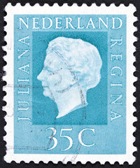 Stamp printed in Netherlands shows portrait of Queen.