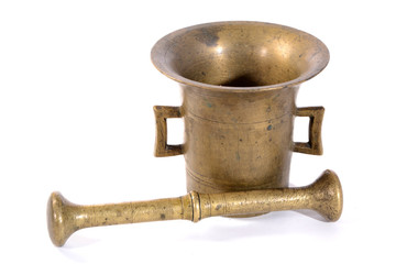 Brass mortar with a pestle isolated on a white background