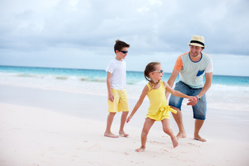 Father with kids at beach