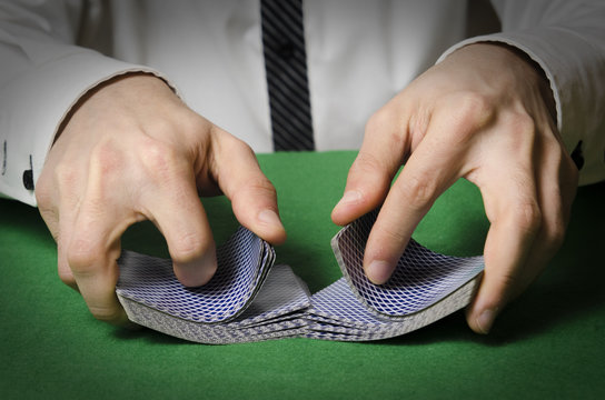 hands shuffling cards casino