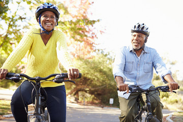 Senior Couple On Cycle Ride In Countryside - obrazy, fototapety, plakaty