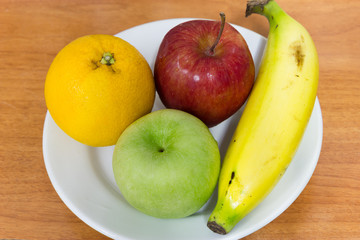 Healthy fruits like banana, oranges and apples