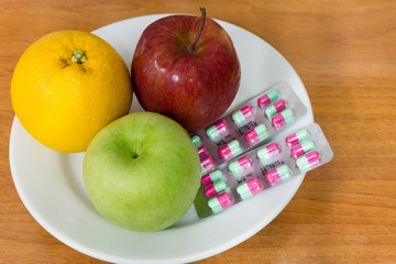Healthy fruits and pills