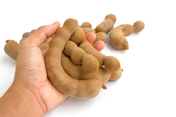 Tamarind in hand isolated on white background