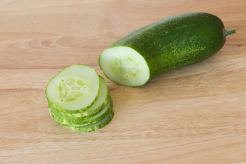 cucumber slices on wooden background