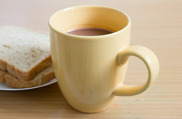 Cup of coffee toast on wooden table