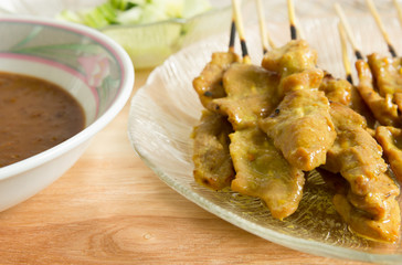 Grilled pork served with peanut sauce