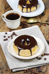 Delicious donut with chocolate on wooden table