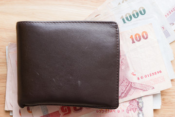 Brown leather wallet with money