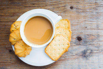 Cup of coffee and cookies (focus on thecoffee)