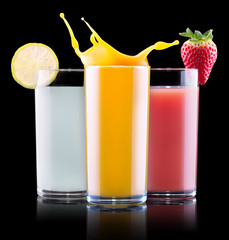 tasty summer fruit drinks in glass with splash