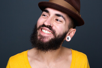 Confident young man with beard smiling