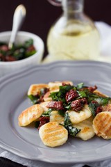 Fried potato gnocchi with sauce of dried tomatoes, spinach