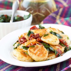Fried potato gnocchi with sauce of dried tomatoes, spinach