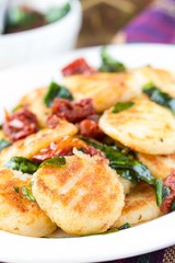 Fried potato gnocchi with sauce of dried tomatoes, spinach