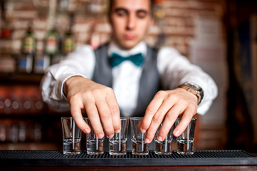 barman preparing shots for cocktail party on bar