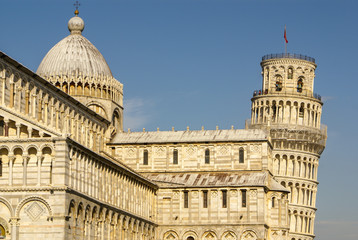 Pisa Cathedral Square with green grass on a meadow and clear blu