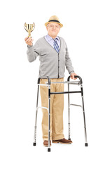 Elderly gentleman with walker holding a gold cup