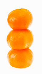 Stacked fresh mandarin isolated on white background.